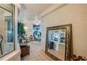View of sunroom from entryway, showing tiled floor and mirror at 4555 S Atlantic Ave # 4304, Ponce Inlet, FL 32127