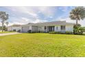 One-story home with gray garage door and landscaped lawn at 31 Sea Harbor E Dr, Ormond Beach, FL 32176