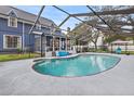 Inviting kidney-shaped pool with screened enclosure, perfect for relaxation at 9 Iroquois Trl, Ormond Beach, FL 32174