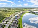 Aerial view of house and neighborhood by the lake at 137 Azure Mist Way, Daytona Beach, FL 32124