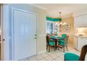 Kitchen features breakfast nook with teal chairs and white cabinets at 4565 S Atlantic Ave # 5308, Port Orange, FL 32127