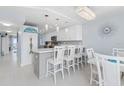 Kitchen with white cabinets, breakfast bar, and dining area at 89 S Atlantic Ave # 1002, Ormond Beach, FL 32176