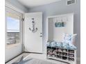 Bright condo entry with bench, shoe storage, and ocean view at 89 S Atlantic Ave # 1002, Ormond Beach, FL 32176