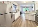 Open kitchen with stainless steel appliances and wood-look flooring at 129 Blue Heron Dr # A, Daytona Beach, FL 32119