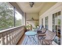 Relaxing screened balcony with wicker furniture and garden at 424 Luna Bella Ln # 222, New Smyrna Beach, FL 32168
