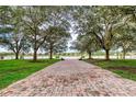 Brick pathway leads to a lakefront view with benches at 424 Luna Bella Ln # 222, New Smyrna Beach, FL 32168