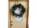 Inviting front door adorned with a unique antler wreath at 216 Rue De Paresse, Tavares, FL 32778