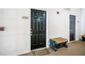 Building entrance with a black door and welcome mat at 280 Celebration Blvd # 203, Celebration, FL 34747