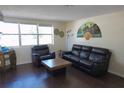 Living room with dark leather furniture and wood-look flooring at 1114 Berkshire Rd, Daytona Beach, FL 32117