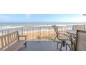 Balcony with ocean view, table and chairs, and bench at 1183 Ocean Shore Blvd # 6040, Ormond Beach, FL 32176