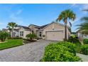 Exterior view of home with paver driveway at 597 Mosaic Blvd, Daytona Beach, FL 32124