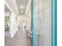 Bright and airy entryway with glass door and tile floors at 2214 Elegant Manor Cir, Edgewater, FL 32141