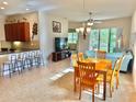 Open concept dining area with a wooden table and kitchen access at 708 Aldenham Ln, Ormond Beach, FL 32174