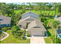 Two-story house with a large yard, situated near a golf course at 7 Jasmine Run, Ormond Beach, FL 32174