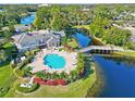 Community pool with lake and lush landscaping at 940 Village Trail # 7-107, Port Orange, FL 32127