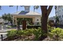 Gated community entrance with lush landscaping and brick accents at 6550 Time Square Ave # 105, Orlando, FL 32835