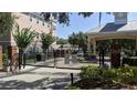 Gated entrance to community, featuring brick columns and wrought iron gates at 6550 Time Square Ave # 105, Orlando, FL 32835