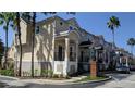 Exterior view of charming townhouses with attractive landscaping at 6550 Time Square Ave # 105, Orlando, FL 32835