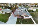 Aerial view of a single-Gathering home with a fenced yard and driveway at 21 Sunset Blvd, Ormond Beach, FL 32176
