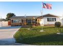 Single-Gathering home with a well-manicured lawn and an American flag at 21 Sunset Blvd, Ormond Beach, FL 32176