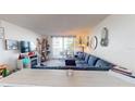 Living room with a sectional sofa, a Christmas tree, and a TV at 2727 N Atlantic Ave # 203, Daytona Beach, FL 32118