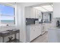 Ocean view kitchen, white cabinets, granite counters at 89 S Atlantic Ave # 1401, Ormond Beach, FL 32176