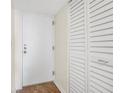 Bright condo entryway with white door and built-in storage at 1 Oceans West Blvd # 5B3, Daytona Beach, FL 32118