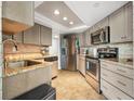 Modern kitchen with granite counters and stainless steel appliances at 1 Oceans West Blvd # 5B3, Daytona Beach, FL 32118