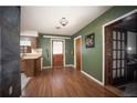 Kitchen with wood flooring, green walls, and door at 9701 E Warm Springs Ave, Coleman, FL 33521