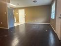 Dark wood floors and neutral-colored walls at 1215 E Hazzard Ave, Eustis, FL 32726