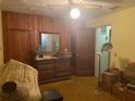Bedroom with wood-paneled walls and vintage furniture at 912 Holiday Ln, Leesburg, FL 34748