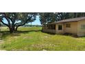 Yellow home with screened porch overlooking water at 10575 Se 95Th Ter, Belleview, FL 34420