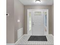 Home entry with white door and tile floor at 1203 Loch Rannoch Ct, Leesburg, FL 34788