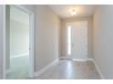 Bright entryway with neutral-toned tile floors and white door at 437 Silver Palm Dr, Haines City, FL 33844