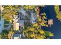 Bird's-eye view showcasing lakefront property and dock at 1241 W Lakeshore Dr, Clermont, FL 34711