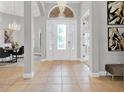 Elegant entryway with a high ceiling and crystal chandelier at 5418 Meadow Hill Loop, Lady Lake, FL 32159
