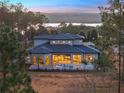 Luxury home with pool and lake view at sunset at 16340 Pendio Dr, Bella Collina, FL 34756