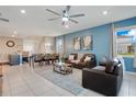 Open concept living and dining area with blue accent wall at 2226 Lelani Cir, Davenport, FL 33897