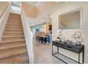 Bright and spacious entryway with staircase and view to kitchen at 2226 Lelani Cir, Davenport, FL 33897