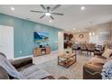 Open living room with fireplace, leather couches, and dining area at 2226 Lelani Cir, Davenport, FL 33897