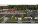 Community view showcasing homes, pond, and lush landscaping at 2720 Dumont Ln, Tavares, FL 32778