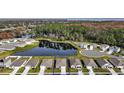 Wide shot of the home and surrounding community with a pond at 2720 Dumont Ln, Tavares, FL 32778