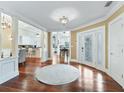 Elegant entryway with hardwood floors and view into the kitchen at 12730 E Highway 25, Ocklawaha, FL 32179