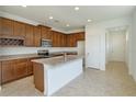 Modern kitchen with island, dark wood cabinets, and granite countertops at 2000 Sunshine Peak Dr, Minneola, FL 34715