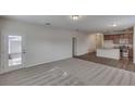 Open living room and kitchen with carpeting and laminate flooring at 2241 Juniper Berry Dr, Minneola, FL 34715