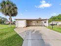 Single-story home with carport and landscaped yard at 1604 Magnolia Ave, The Villages, FL 32159
