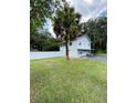 House exterior showcasing a white house and grassy yard at 1501 N Cr 19A, Eustis, FL 32726