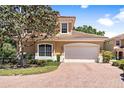 Two story home with brick driveway and lush landscaping at 26142 Avenida Las Colinas # 2B, Howey In The Hills, FL 34737