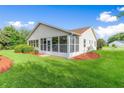 Back exterior view of house with screened porch and yard at 1019 Dundee Cir, Leesburg, FL 34788