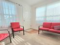 Living area featuring red armchairs and a sofa at 2542 Hubbs St, The Villages, FL 32163